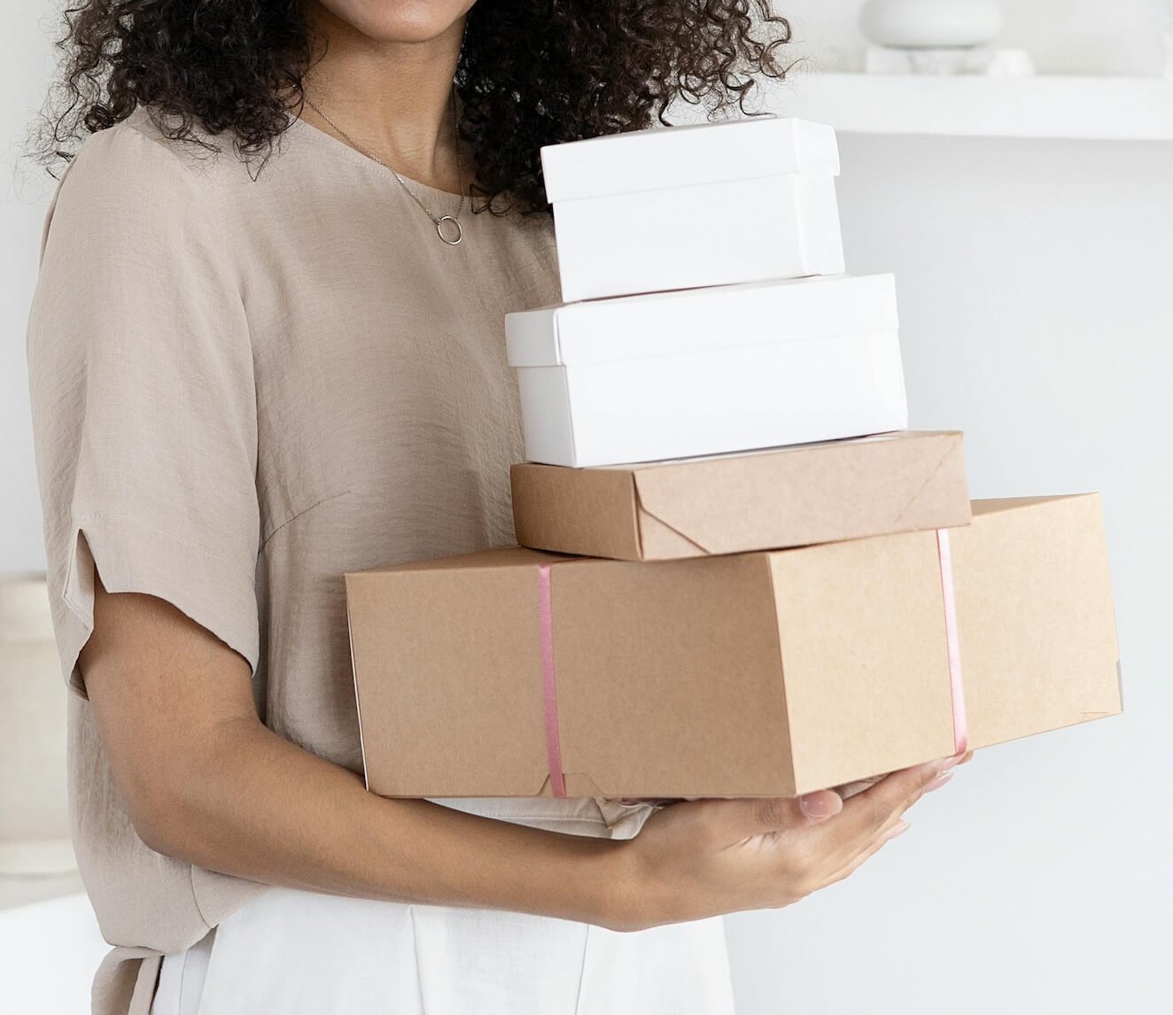 holding a set of gift boxes representing a curated gifts three-month experience with ongoing support for conscious choosing